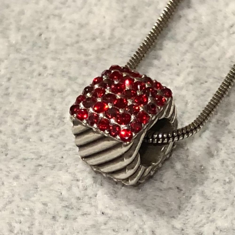 This is a silver Brighton charm necklace